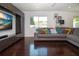 Bright living room with a modern entertainment center and plush gray sofa at 2238 Rose St, Sarasota, FL 34239