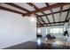 Bright living room with exposed beams, opening up to an adjacent kitchen and office area at 2238 Rose St, Sarasota, FL 34239