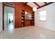 Bright, empty home office featuring wood paneled wall with built-in shelves at 2238 Rose St, Sarasota, FL 34239