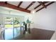 Bright office with hardwood floors, beamed ceiling, large slider, and backyard access at 2238 Rose St, Sarasota, FL 34239