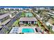 An aerial view showcases a beautiful condo community with a swimming pool, tennis court, and waterfront access at 245 Coldeway Dr # B10, Punta Gorda, FL 33950