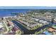 Stunning aerial view of a waterfront community with canals, boat docks, tennis courts, and picturesque residences at 245 Coldeway Dr # B10, Punta Gorda, FL 33950