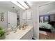 Bright bathroom featuring a marble countertop vanity and entry to the bedroom at 245 Coldeway Dr # B10, Punta Gorda, FL 33950