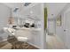Well-lit kitchen with white cabinets, stainless steel appliances, and a breakfast bar at 245 Coldeway Dr # B10, Punta Gorda, FL 33950