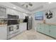 Cozy kitchen boasts stainless steel appliances, crisp white cabinetry, and unique decor for a modern feel at 245 Coldeway Dr # B10, Punta Gorda, FL 33950