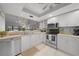 Well-lit kitchen featuring sleek stainless steel appliances, ample counter space, and bright white cabinetry at 245 Coldeway Dr # B10, Punta Gorda, FL 33950