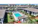 Aerial view of a condo complex featuring a pool, lounge chairs, and lush landscaping in a serene setting at 245 Coldeway Dr # B10, Punta Gorda, FL 33950