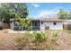 Exterior of home and screened in patio with lawn at 2922 Williamsburg St, Sarasota, FL 34231