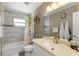 Bathroom features a shower-tub, a sink with a counter, a mirror, and decor at 2922 Williamsburg St, Sarasota, FL 34231