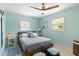 Relaxing bedroom with soft blue walls, ceiling fan, and neutral bedding at 2922 Williamsburg St, Sarasota, FL 34231