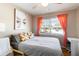 Cozy bedroom with a ceiling fan, and a large window with bright curtains allowing ample natural light at 2922 Williamsburg St, Sarasota, FL 34231
