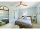 Cozy bedroom featuring a ceiling fan, a window with blinds and a framed mirror at 2922 Williamsburg St, Sarasota, FL 34231