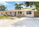 Inviting single-story home featuring a well-maintained lawn and a bright blue front door at 2922 Williamsburg St, Sarasota, FL 34231