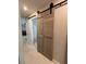 Hallway featuring barn doors, and a glimpse into the living room at 2922 Williamsburg St, Sarasota, FL 34231