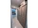 Hallway featuring barn doors and a view into the living room at 2922 Williamsburg St, Sarasota, FL 34231