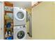 Laundry room features a stacked washer and dryer set, and shelving at 2922 Williamsburg St, Sarasota, FL 34231