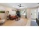 Inviting living room with large window, ceiling fan, and a comfortable leather sofa at 2922 Williamsburg St, Sarasota, FL 34231