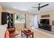 Comfortable living room featuring neutral tones and modern furnishings and large TV at 2922 Williamsburg St, Sarasota, FL 34231