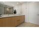 Modern bathroom featuring a wooden vanity, quartz countertop, and a glass-enclosed shower with sleek fixtures at 301 Quay Commons # 1204, Sarasota, FL 34236