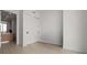 Bedroom showcasing tiled floor, closet, and entryway to a modern bathroom at 301 Quay Commons # 1204, Sarasota, FL 34236