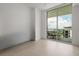 Bright bedroom featuring neutral tile floors, large windows, and balcony access with outdoor seating at 301 Quay Commons # 1204, Sarasota, FL 34236