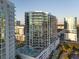 Modern condo building featuring balconies and a pool, with surrounding city views at 301 Quay Commons # 1610, Sarasota, FL 34236