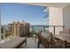 Relaxing balcony seating with amazing views of the water and surrounding city buildings on a clear, sunny day at 301 Quay Commons # 1610, Sarasota, FL 34236