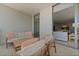 Relaxing condo balcony with cozy seating, offering seamless indoor-outdoor living and serene space at 301 Quay Commons # 1610, Sarasota, FL 34236