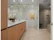 Modern bathroom showcasing double sinks, a glass-enclosed shower, and wood cabinetry at 301 Quay Commons # 1610, Sarasota, FL 34236