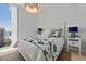 Bright bedroom featuring a large window and a bed with decorative pillows at 301 Quay Commons # 1610, Sarasota, FL 34236