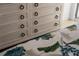 Rustic wood dresser with unique hardware, next to a stylishly decorated bed at 301 Quay Commons # 1610, Sarasota, FL 34236