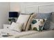 Close-up of the bed, with various pillows and a white headboard with detailing at 301 Quay Commons # 1610, Sarasota, FL 34236
