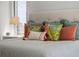 Comfortable bed adorned with colorful decorative pillows at 301 Quay Commons # 1610, Sarasota, FL 34236