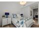 Bright bedroom features a queen bed, floral bedding, stylish nightstands, and a modern light fixture at 301 Quay Commons # 1610, Sarasota, FL 34236