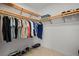 Walk-in closet features wood shelving and ample storage space for clothing and shoes at 301 Quay Commons # 1610, Sarasota, FL 34236