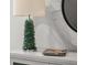 Coastal decor in the condo includes a seastone lamp, a round mirror, and a magazine at 301 Quay Commons # 1610, Sarasota, FL 34236