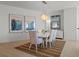 Elegant dining room featuring a stylish chandelier, modern art, and seating for six at 301 Quay Commons # 1610, Sarasota, FL 34236