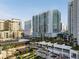 Contemporary white high-rise buildings with balconies and sleek design, surrounded by lush landscaping and city views at 301 Quay Commons # 1610, Sarasota, FL 34236