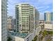Modern high-rise building featuring multiple balconies and a rooftop pool at 301 Quay Commons # 1610, Sarasota, FL 34236