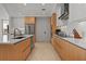 Well-equipped kitchen featuring modern stainless steel appliances, a sink, and sleek cabinetry for a contemporary design at 301 Quay Commons # 1610, Sarasota, FL 34236