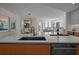Open-concept kitchen showcasing a large island, modern appliances, and stylish décor with views of the dining and living areas at 301 Quay Commons # 1610, Sarasota, FL 34236