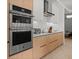 Modern kitchen with stainless steel appliances, oven, and sleek cabinetry perfect for cooking and entertaining at 301 Quay Commons # 1610, Sarasota, FL 34236