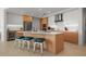 Elegant kitchen featuring an island, modern appliances, sleek cabinetry, and stylish bar stool seating at 301 Quay Commons # 1610, Sarasota, FL 34236
