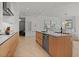 Spacious kitchen featuring a large island with a sink, stainless steel appliances, and modern cabinetry at 301 Quay Commons # 1610, Sarasota, FL 34236