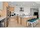 Modern kitchen featuring sleek cabinetry, stainless steel appliances, and a stylish island with seating at 301 Quay Commons # 1610, Sarasota, FL 34236