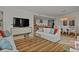 Open-concept living room with modern furnishings, light wood floors, and an open layout leading to the kitchen at 301 Quay Commons # 1610, Sarasota, FL 34236