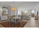 Open-concept living and dining area with contemporary decor, lots of light, and city views at 301 Quay Commons # 1610, Sarasota, FL 34236