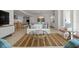 Bright and inviting living room with modern furnishings, light wood floors, and open layout to the kitchen at 301 Quay Commons # 1610, Sarasota, FL 34236