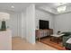 The condo's living room includes a stylish TV console and a unique chandelier at 301 Quay Commons # 1610, Sarasota, FL 34236