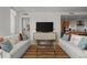 Open living room featuring modern seating, a large television, and seamless transition to the adjacent kitchen area at 301 Quay Commons # 1610, Sarasota, FL 34236